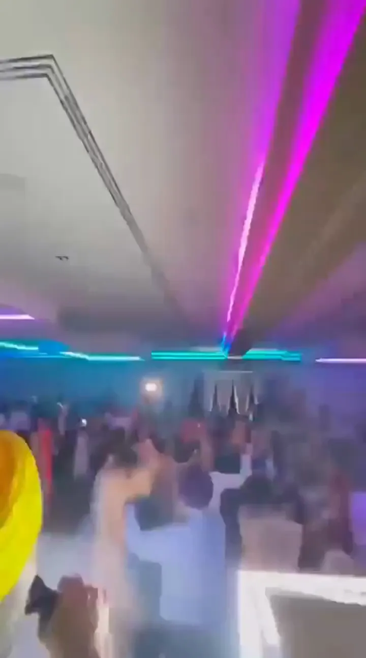 Guests and dancers on a crowded reception dance floor