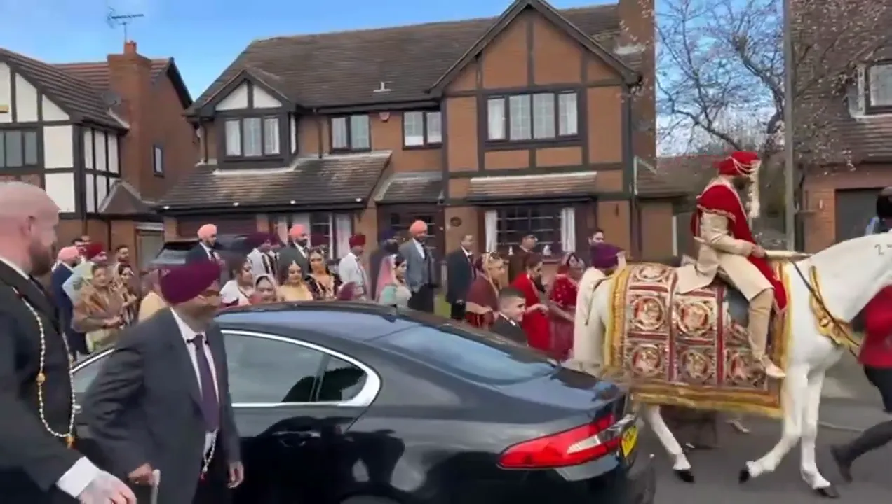 Bhangra dancers leading a baraat, Devizes