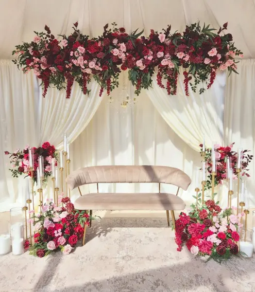 Red and white florals over draped sofa