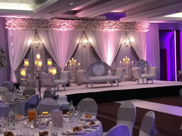 Purple-lit draped stage