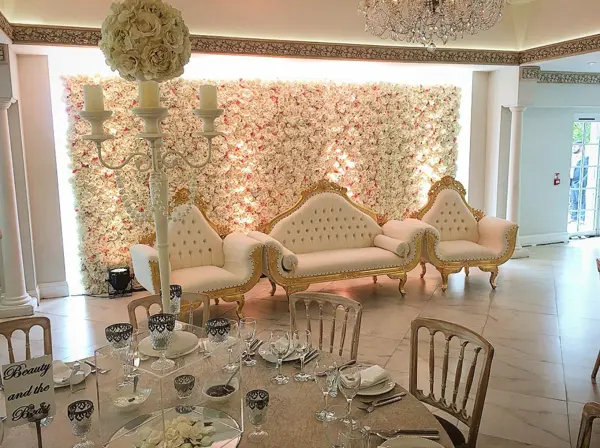 Flower wall stage with ornate sofas