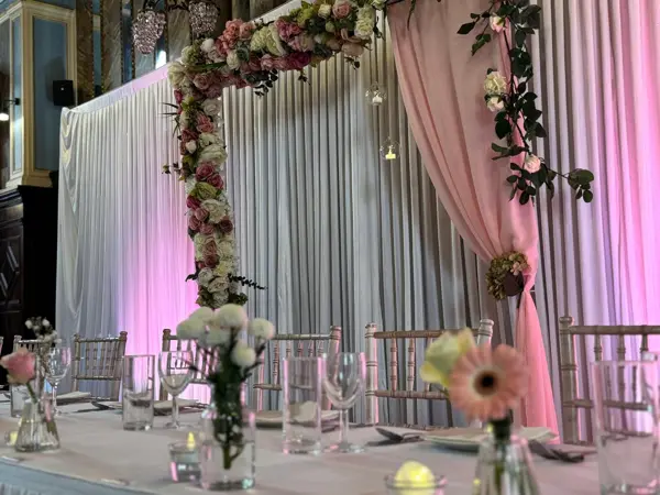 Pink draped stage with floral garlands