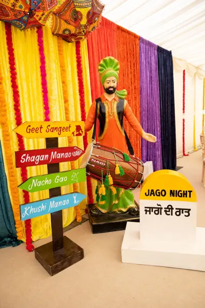 Jago night signage with a Punjabi village theme