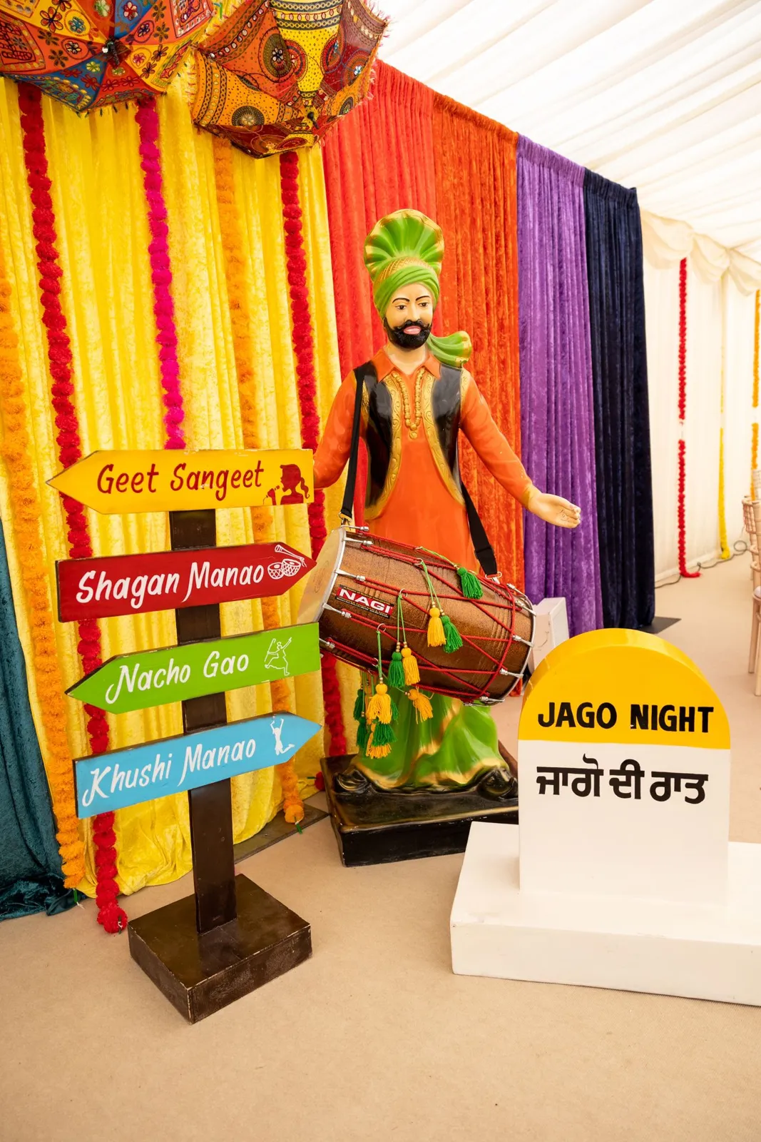 Jago night signage with a Punjabi village theme