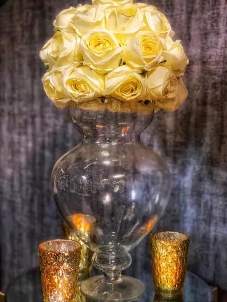 Yellow rose vase with gold votives