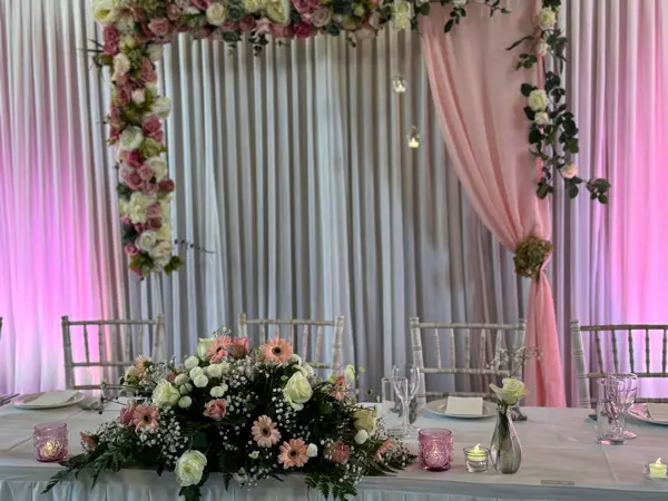 Pink floral backdrop with ivory drapes