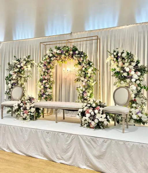 White floral arches on a stage
