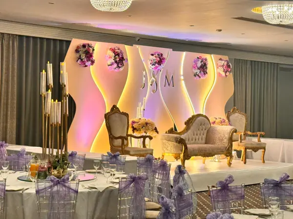 Curved backlit stage with gold sofa