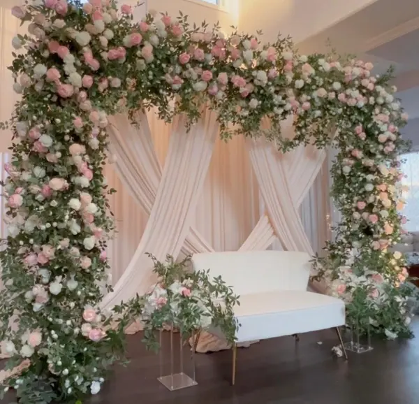 Pink floral arch over a white sofa