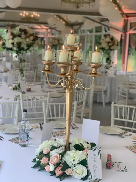 Gold candelabra with white roses