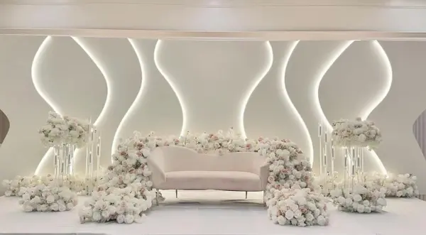 White sculpted stage with florals