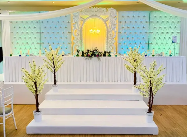 White stage with steps and blossom trees