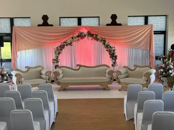 Floral arch stage at a community hall