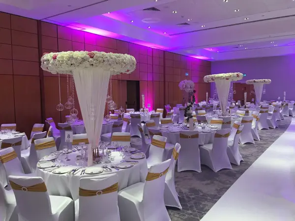 Floating floral centrepieces in a purple ballroom