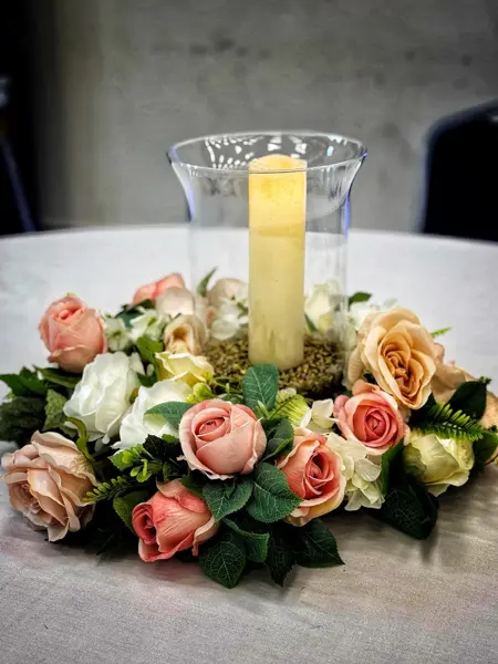 Peach roses with a hurricane candle