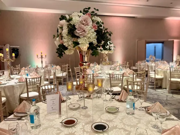 Rose and peony centrepieces on dining tables