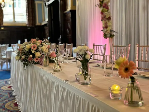Top table with pink florals and candles