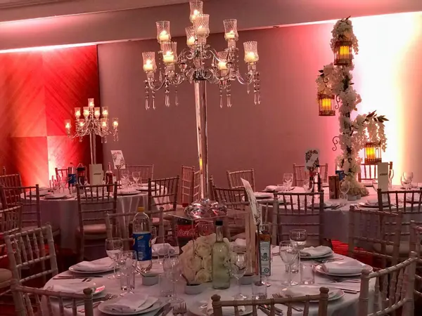 Red-lit room with candelabra centrepieces