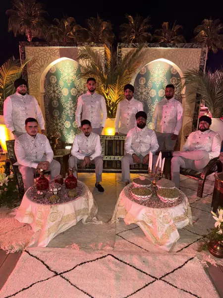 Dhol team in white sherwanis at a mehndi set-up abroad