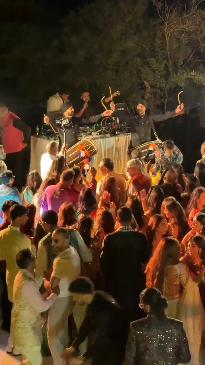 Two dhol players performing a Bollywood party set