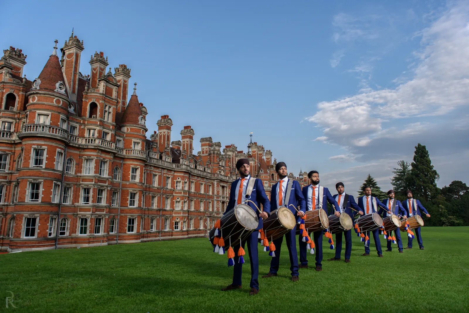 Dhol team lined up on the lawn at Royal Holloway, Egham