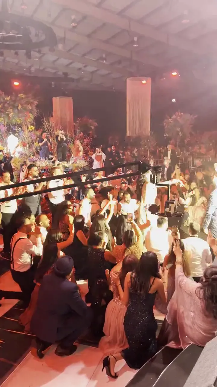 Five dhol players and a sax player performing Freed From Desire
