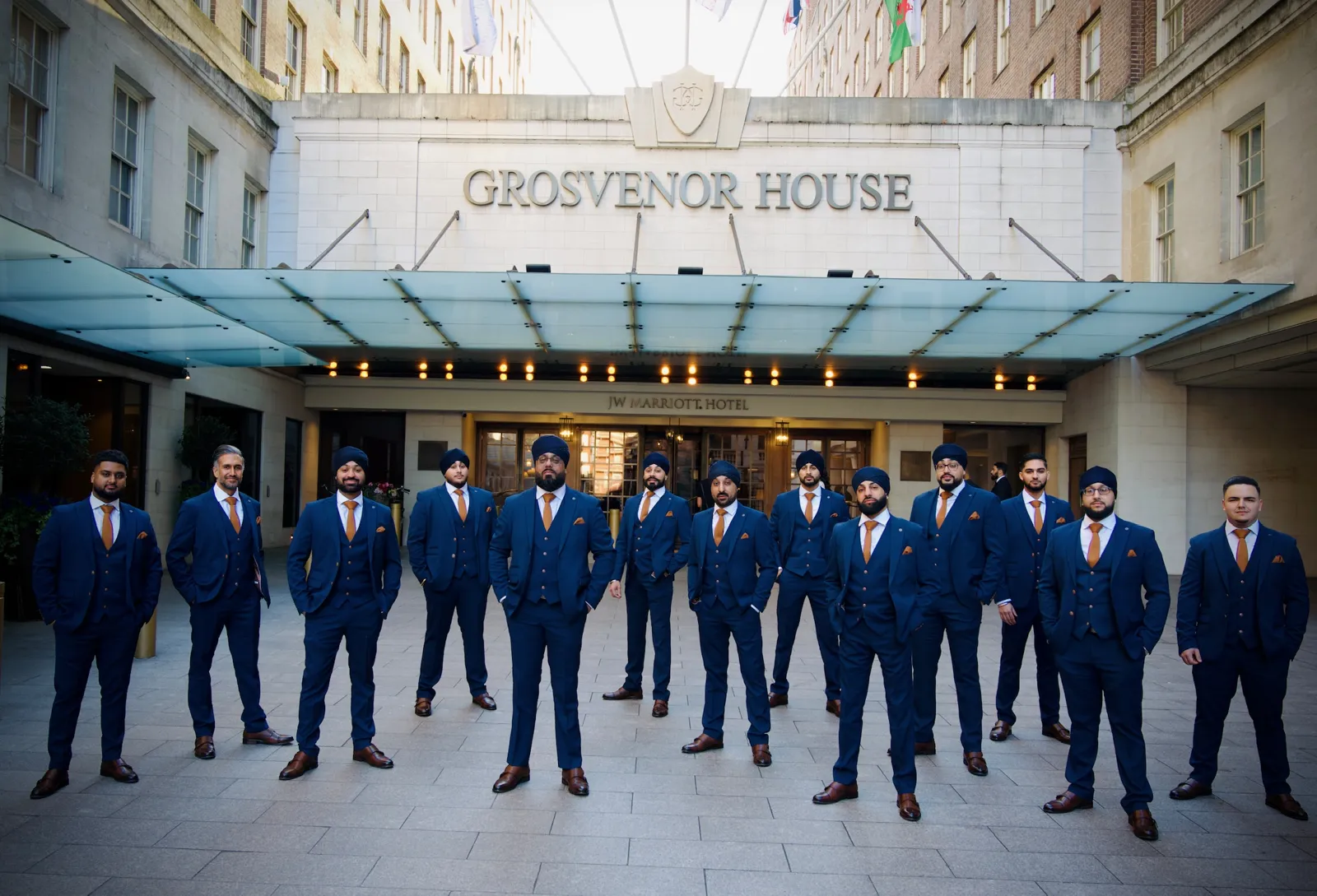 Dhol team in matching suits outside Grosvenor House, London