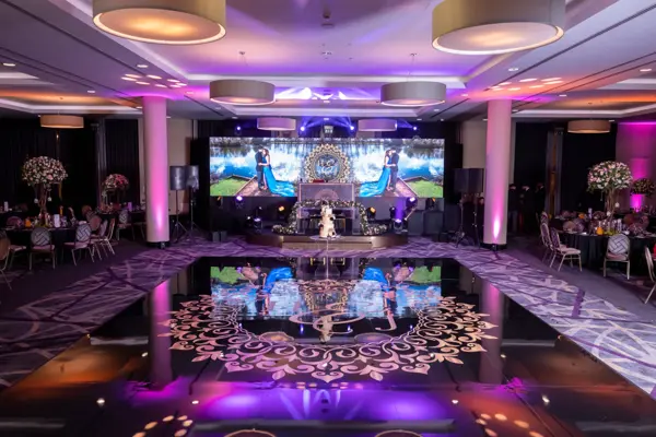 Black gloss dance floor reflecting an LED wall at the Heston Hyde Hotel