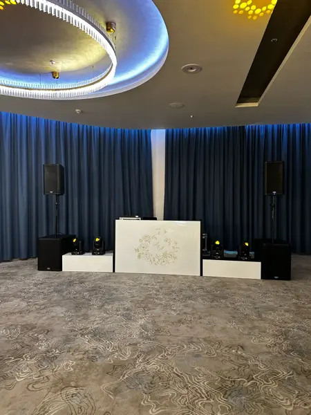 Compact white DJ booth with speakers and lights