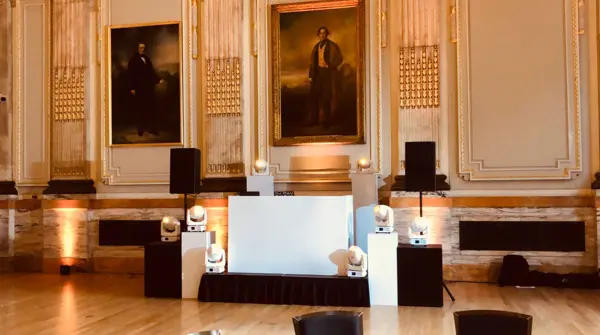 DJ booth and uplighting in a panelled heritage room