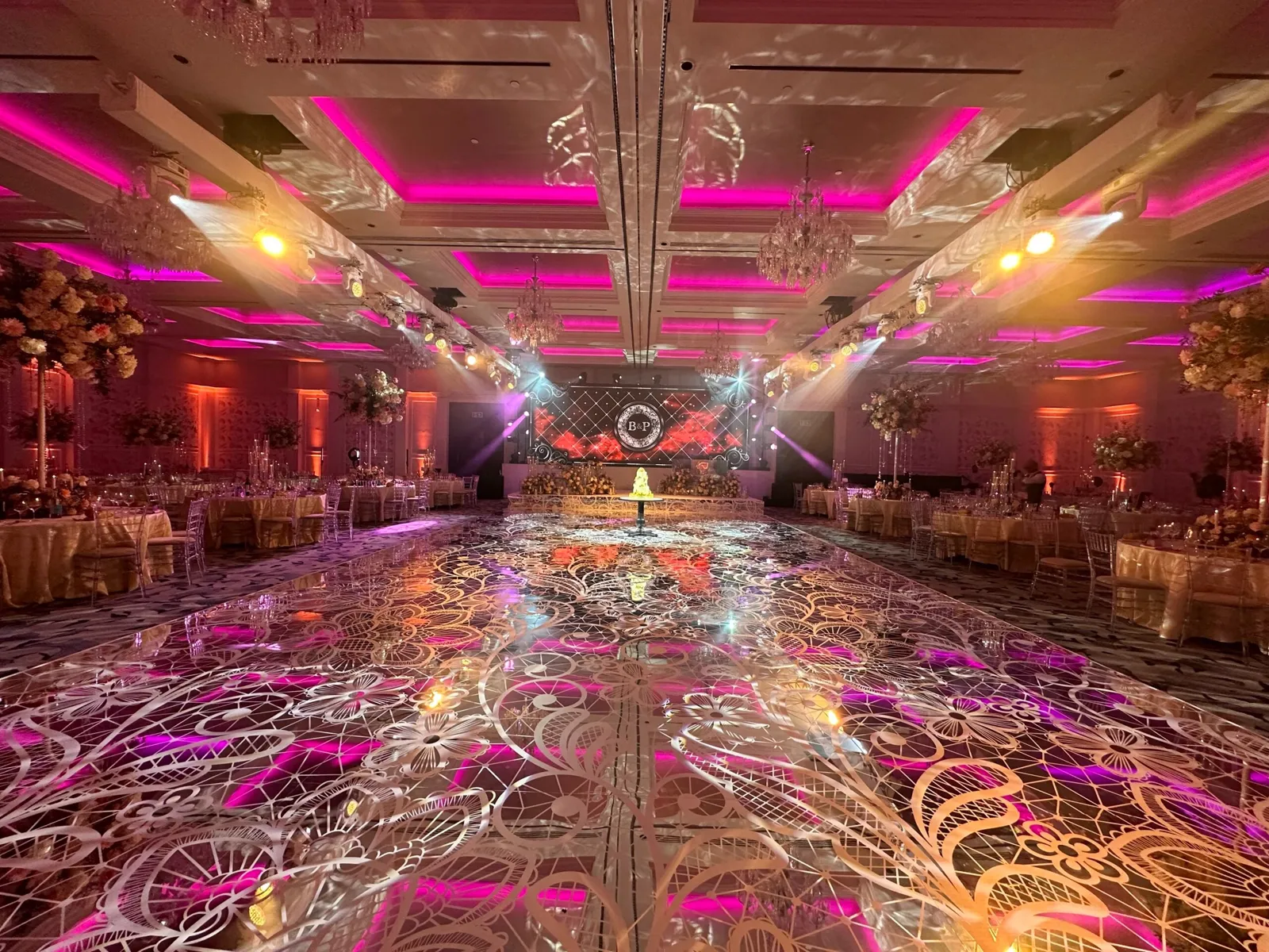 Ballroom with pink lighting and a printed dance floor at Fairmont Windsor Park