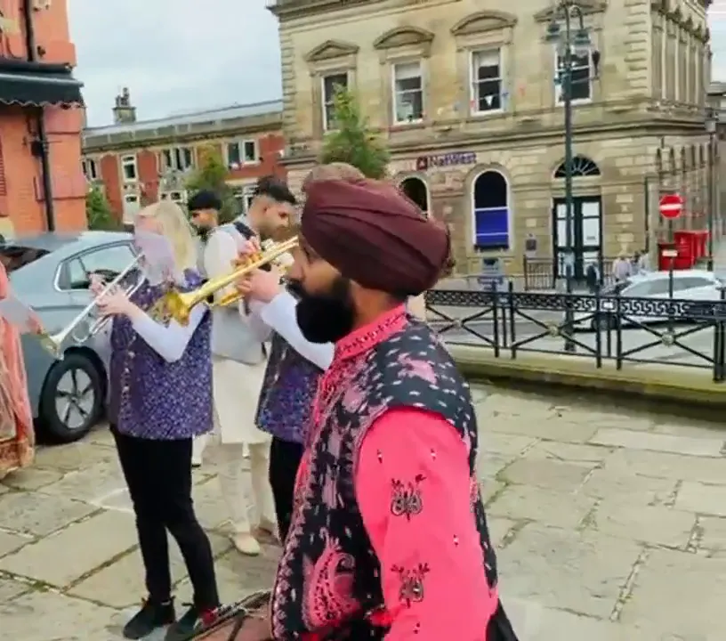 Indian band baja playing at a wedding baraat