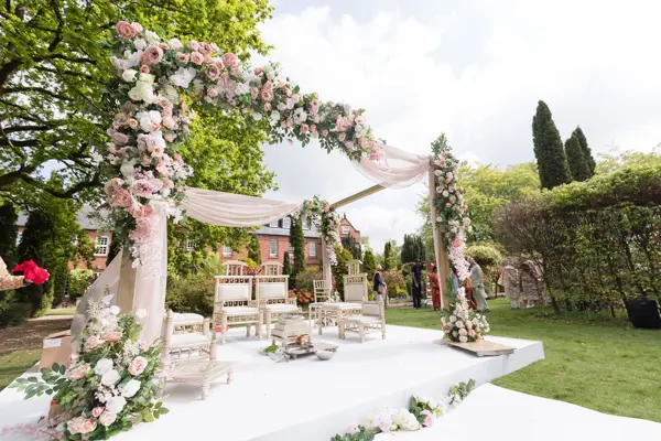 Floral wooden mandap on a lawn