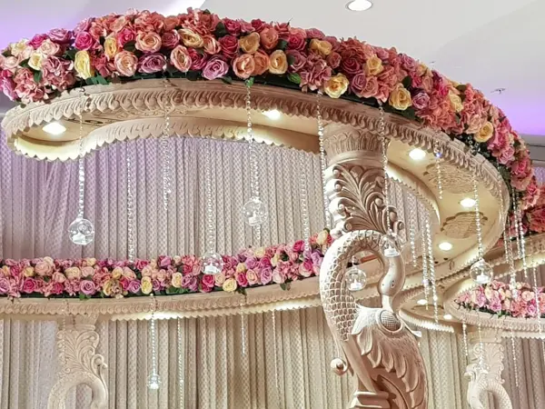 Close-up of a mandap canopy with roses and crystal drops