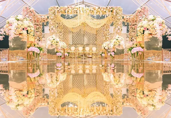 Floral mandap reflected in a mirrored floor