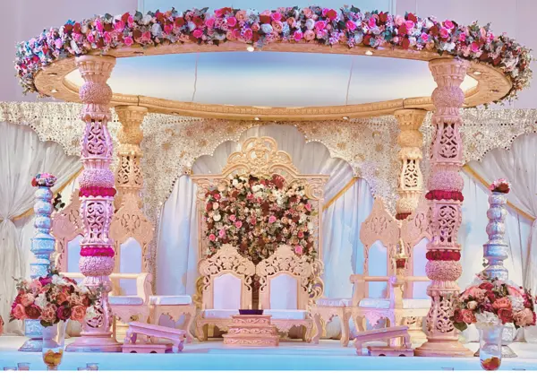 Round mandap with pink pillars and floral canopy