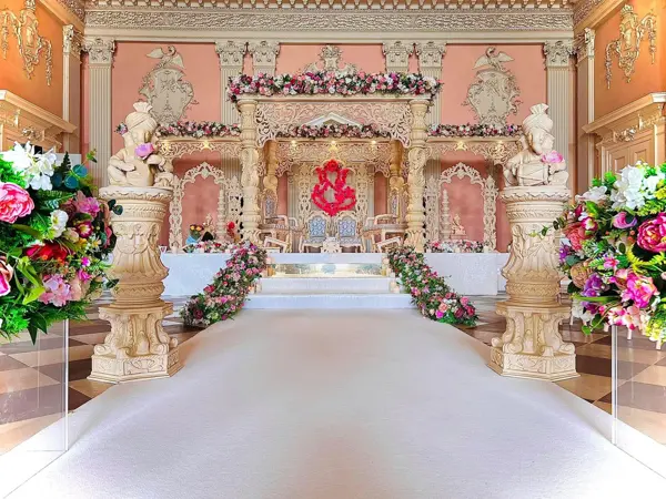 Mandap with carved statues and urns framing the walkway
