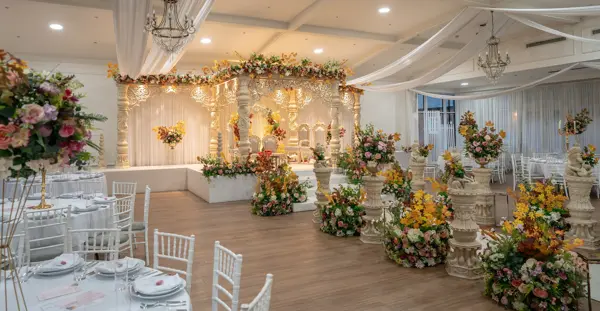 Mandap and floral displays in a reception room