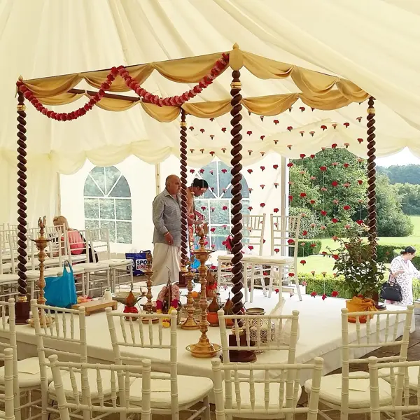 Light mandap with hanging garlands in a marquee