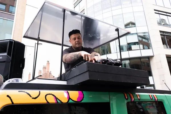 DJ playing from the roof booth of the truck