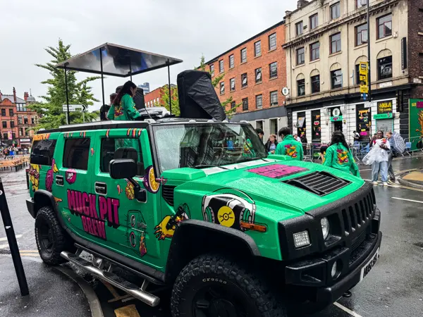 Green wrapped DJ truck parked in a city centre