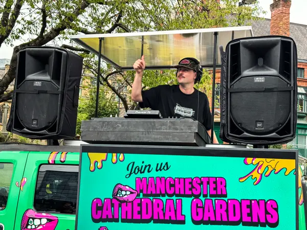 DJ with speakers on top of a wrapped truck