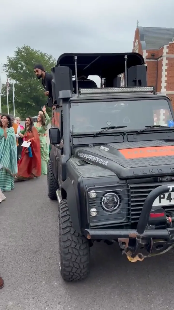 A baraat procession following the DJ truck