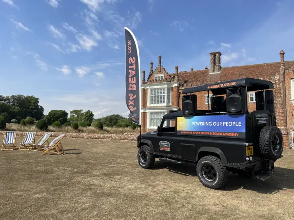 DJ truck with a corporate banner at a country house event