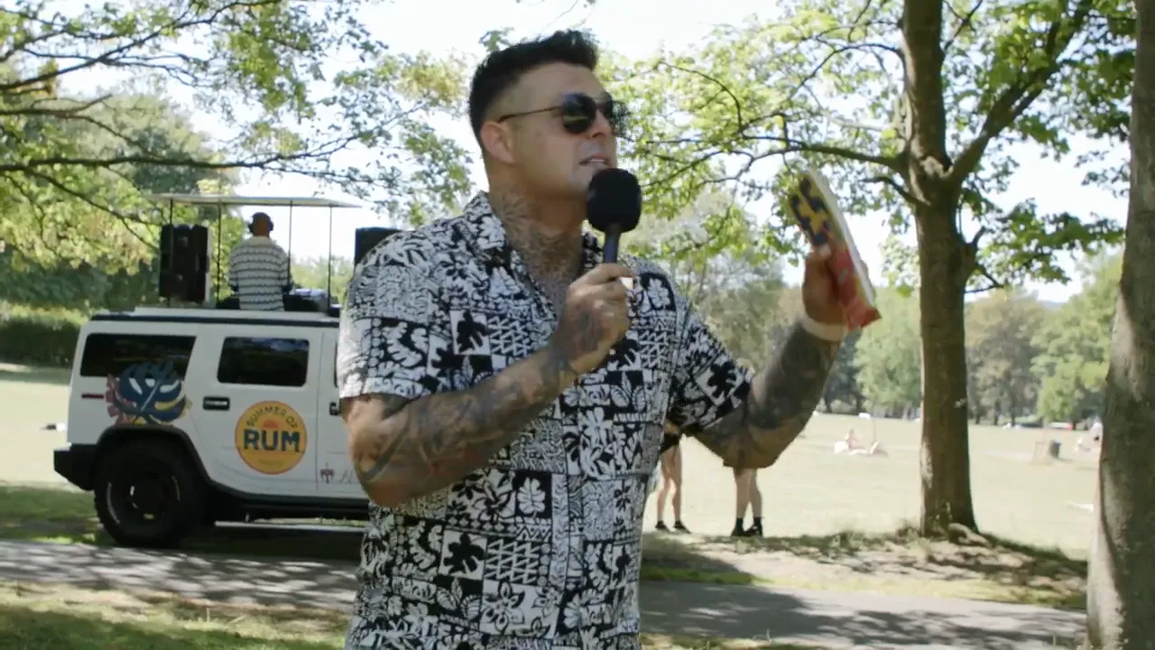 DJ truck brand activation with a host and dancers in a park