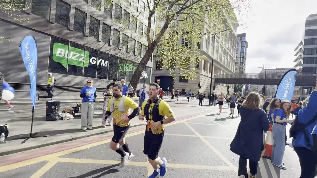 Charity supporters and runners passing the DJ truck on a city marathon route