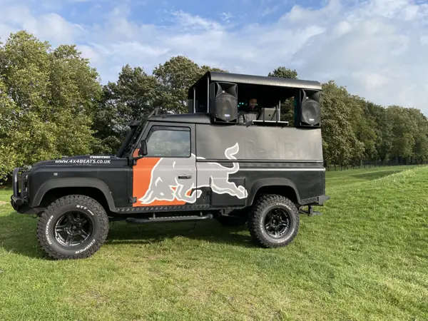 DJ truck with roof sound system parked on a lawn