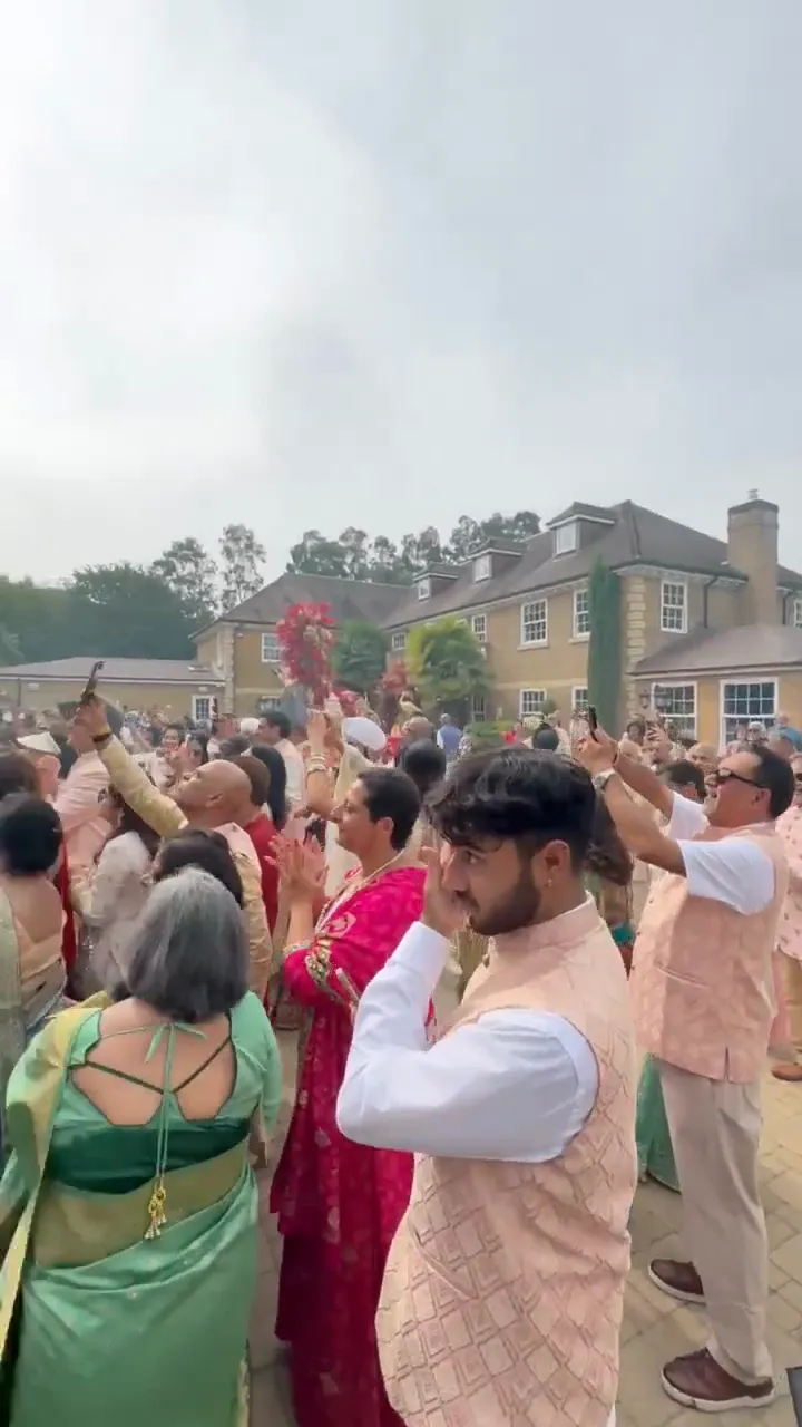 Guests dancing in coloured smoke behind the DJ truck
