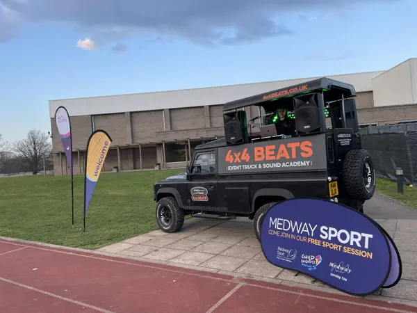 DJ truck at a sports day by an athletics track