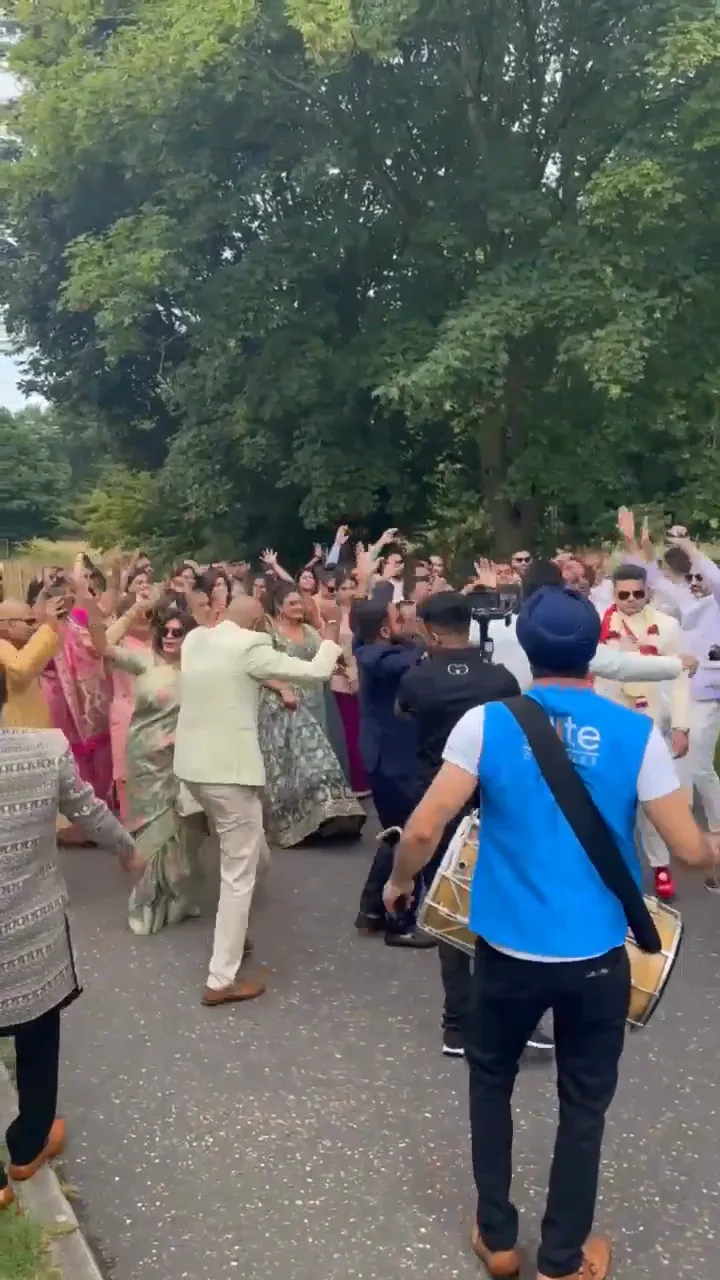 Guests dancing on the road during a baraat